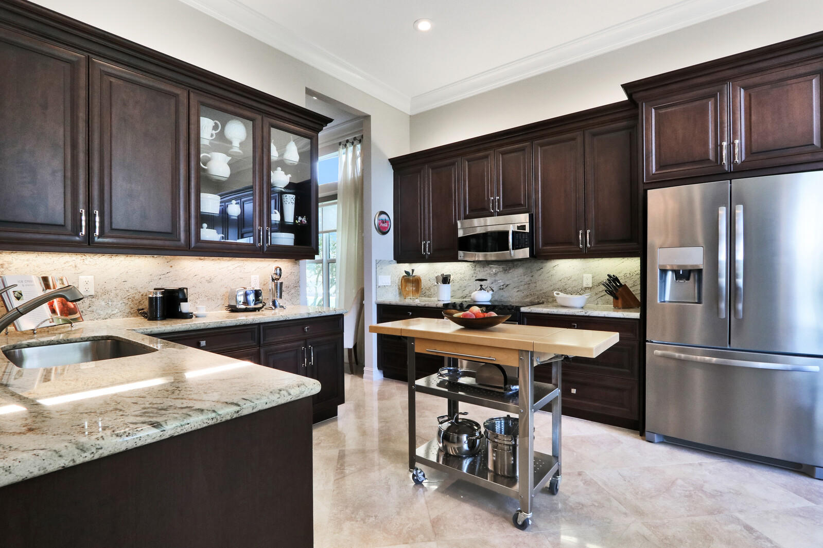 6967 Corning Circle Boynton Beach, FL 33437 - Photo 20 of 62 a kitchen with granite countertop a refrigerator stove top oven a sink and dishwasher with wooden floor