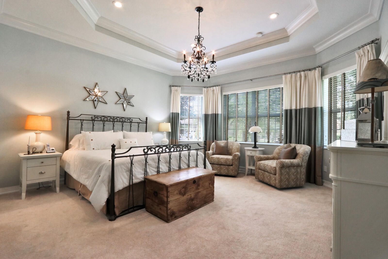 6967 Corning Circle Boynton Beach, FL 33437 - Photo 29 of 62 a spacious bedroom with a bed and a chandelier