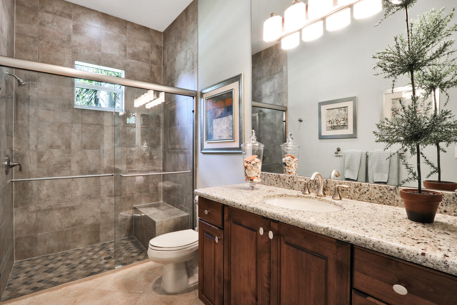 6967 Corning Circle Boynton Beach, FL 33437 - Photo 31 of 62 a bathroom with a granite countertop sink a toilet and shower