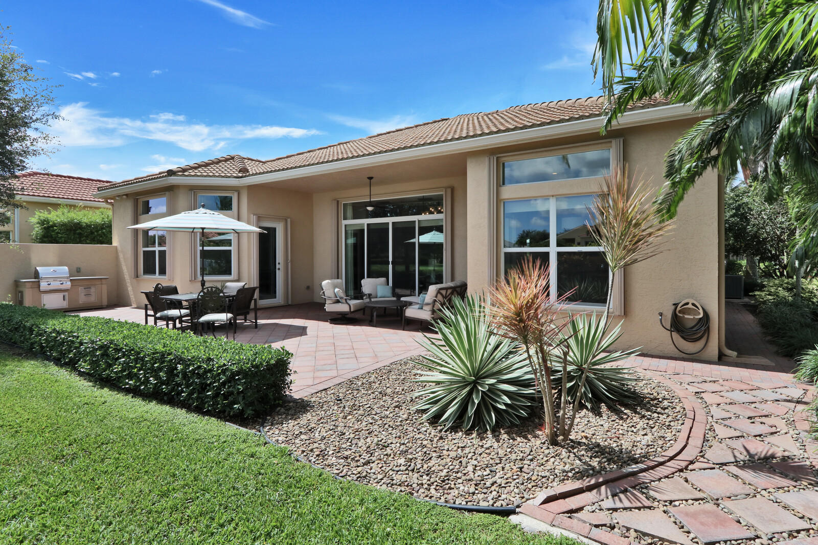 6967 Corning Circle Boynton Beach, FL 33437 - Photo 35 of 62 a front view of house with yard and outdoor seating