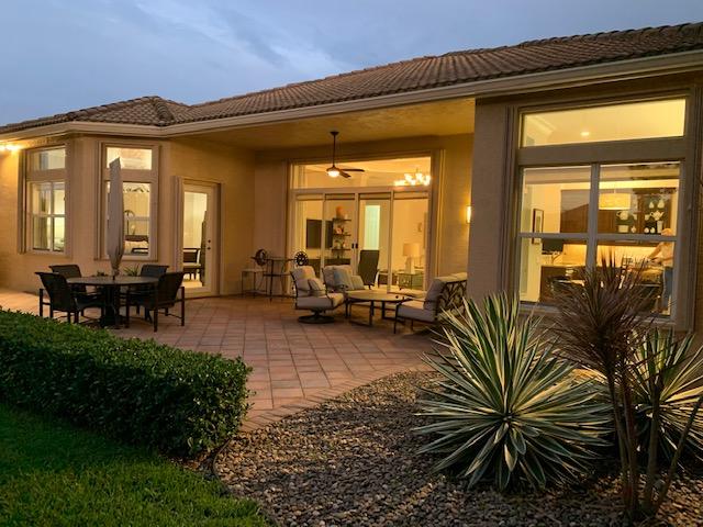 6967 Corning Circle Boynton Beach, FL 33437 - Photo 36 of 62 a living room with furniture and a floor to ceiling window