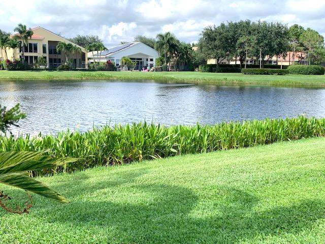 6967 Corning Circle Boynton Beach, FL 33437 - Photo 40 of 62 a view of a lake with a house in the background