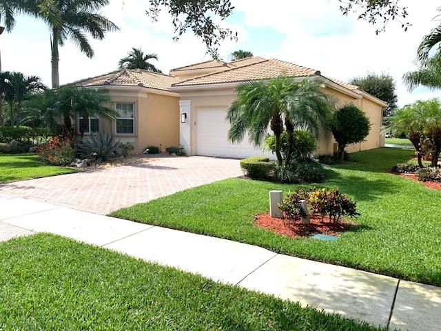 6967 Corning Circle Boynton Beach, FL 33437 - Photo 5 of 62 a front view of a house with a garden and plants