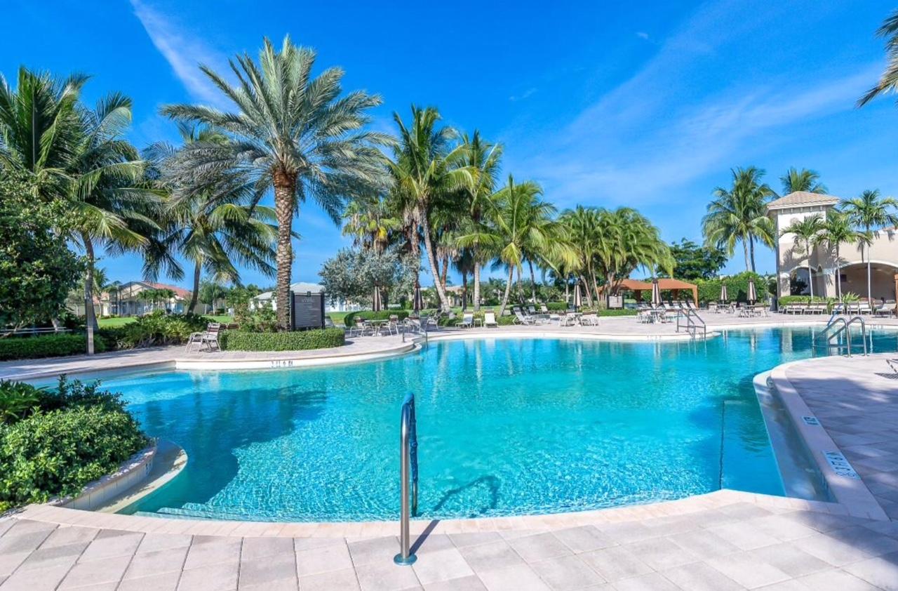 6967 Corning Circle Boynton Beach, FL 33437 - Photo 60 of 62 a view of swimming pool with outdoor seating and plants