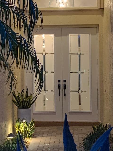 6967 Corning Circle Boynton Beach, FL 33437 - Photo 8 of 62 a potted plant sitting in front of a door