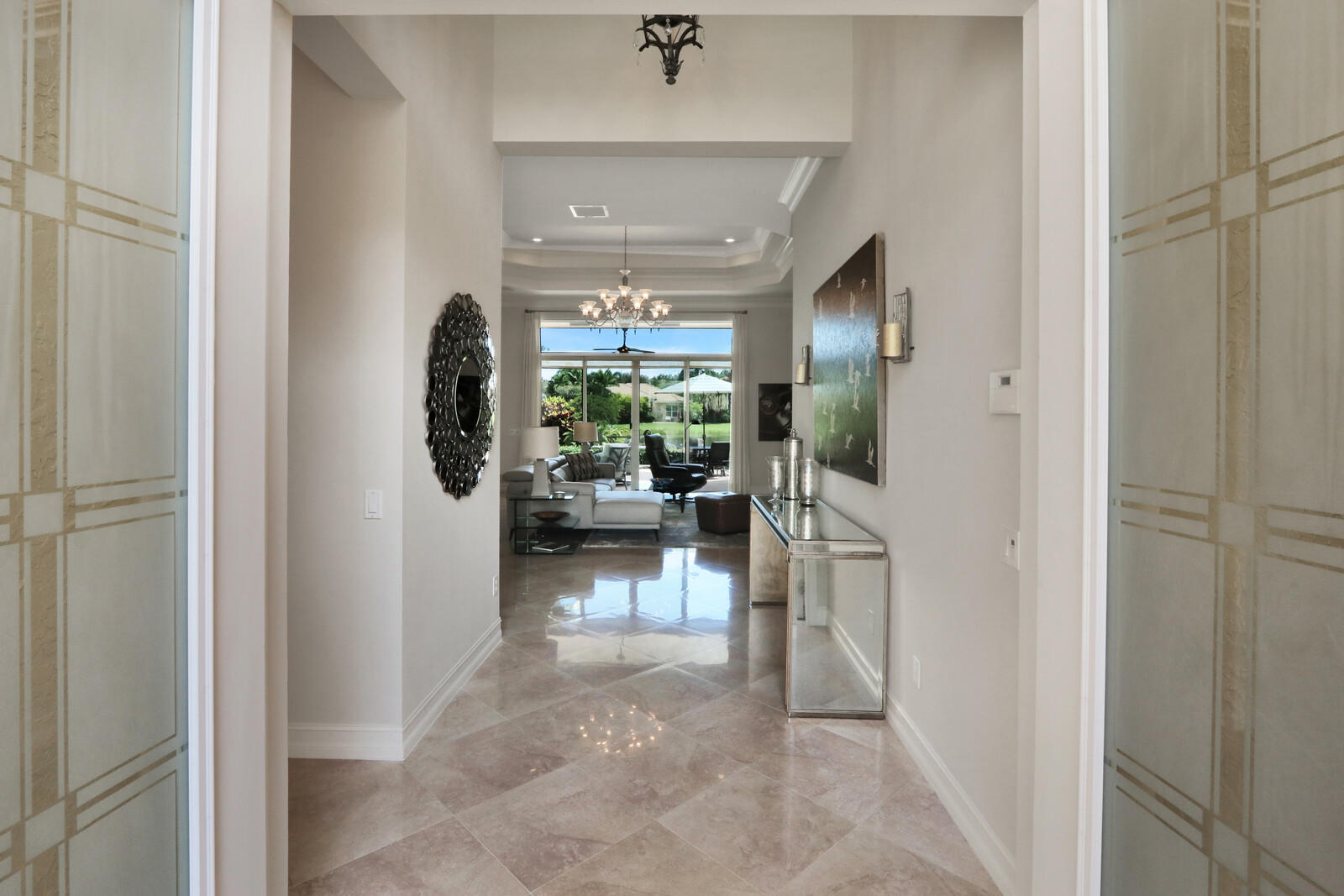 6967 Corning Circle Boynton Beach, FL 33437 - Photo 9 of 62 a view of a hallway and a livingroom with furniture