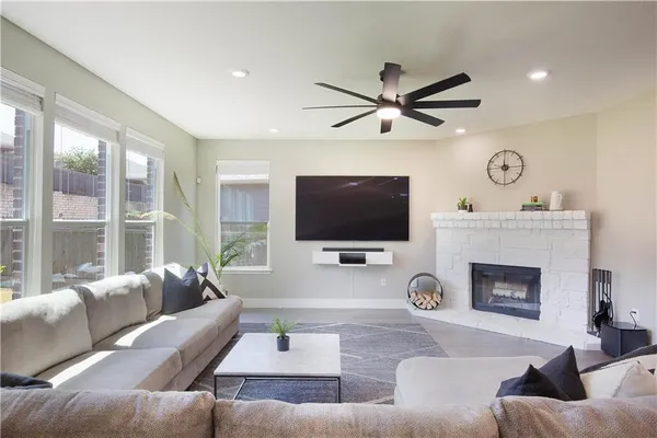 a living room with furniture a fireplace and a flat screen tv