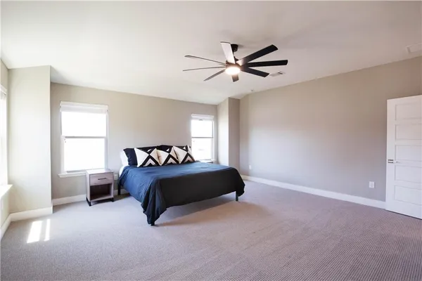 a spacious bedroom with a bed and window