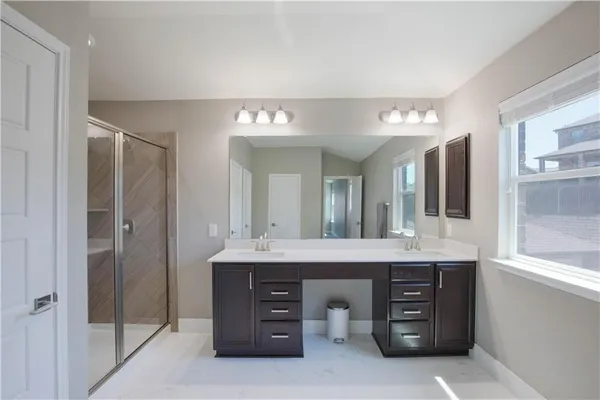 a spacious bathroom with a granite countertop sink and a mirror