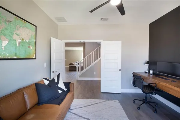 a living room with furniture and a piano