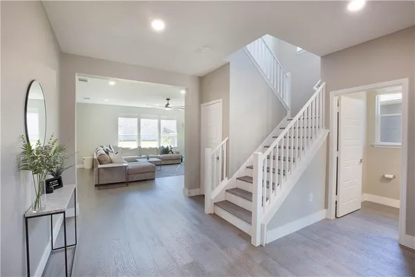 a view of a livingroom with furniture and staircase