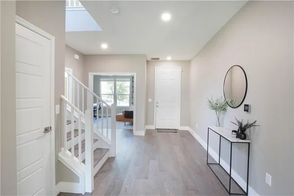 a view of an entryway with wooden floor