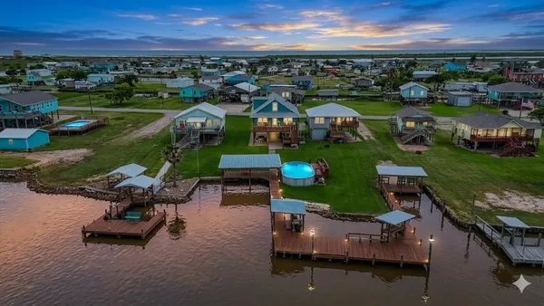 an aerial view of a house with outdoor space pool lake view and mountain view in back