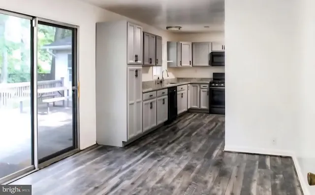 a kitchen with granite countertop a refrigerator and a stove