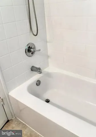 a bathroom with a tub and a shower