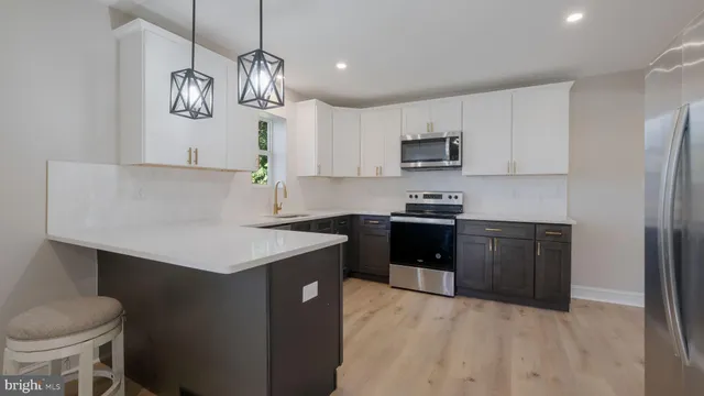 a kitchen with stainless steel appliances a sink stove and refrigerator
