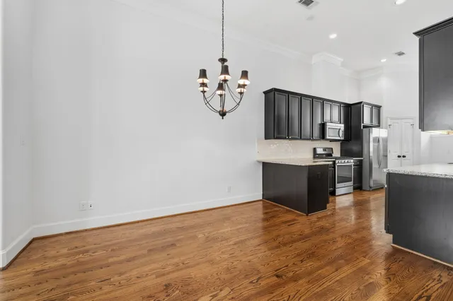 a view of kitchen with stainless steel appliances granite countertop a refrigerator and a sink