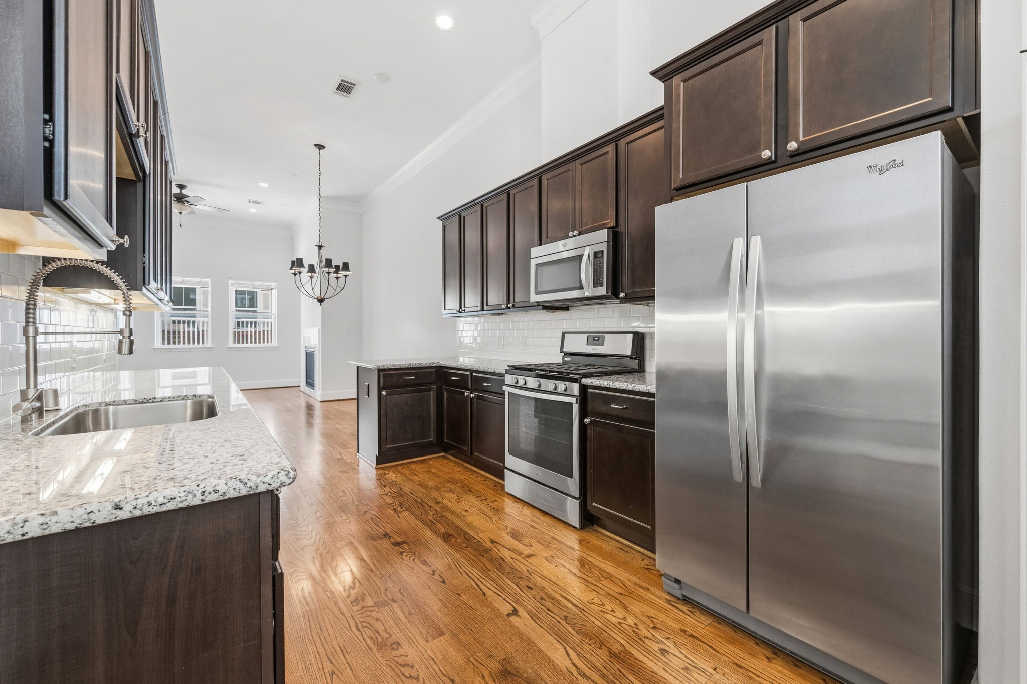617 West 24th Street Houston, TX 77008 - Photo 15 of 28 a kitchen with granite countertop a refrigerator a sink a stove and oven