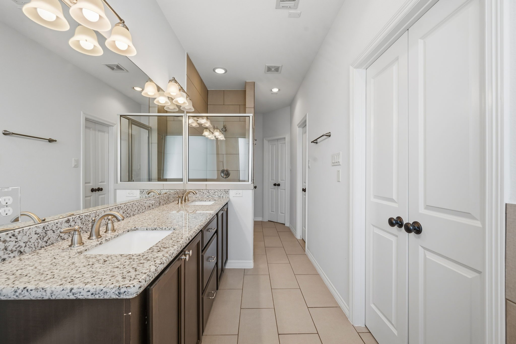 617 West 24th Street Houston, TX 77008 - Photo 22 of 28 a bathroom with a granite countertop sink a mirror and shower
