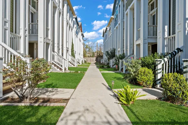 a view of a pathway both side of the house