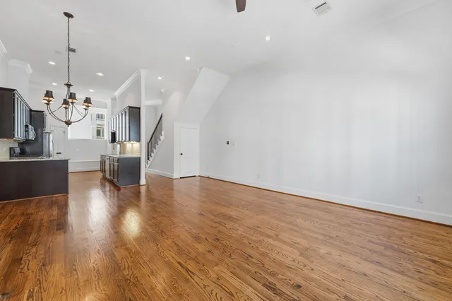 a view of a living room and kitchen with wooden floor