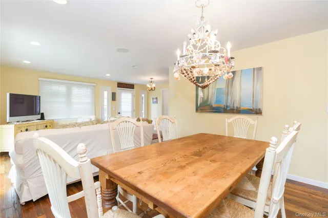 a view of a dining room with furniture and a chandelier
