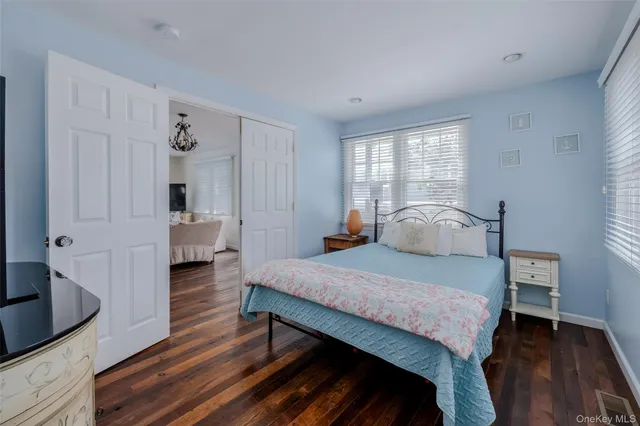 a bedroom with a bed and a view of kitchen