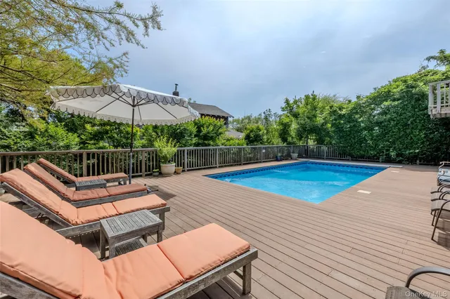 swimming pool view with a seating space