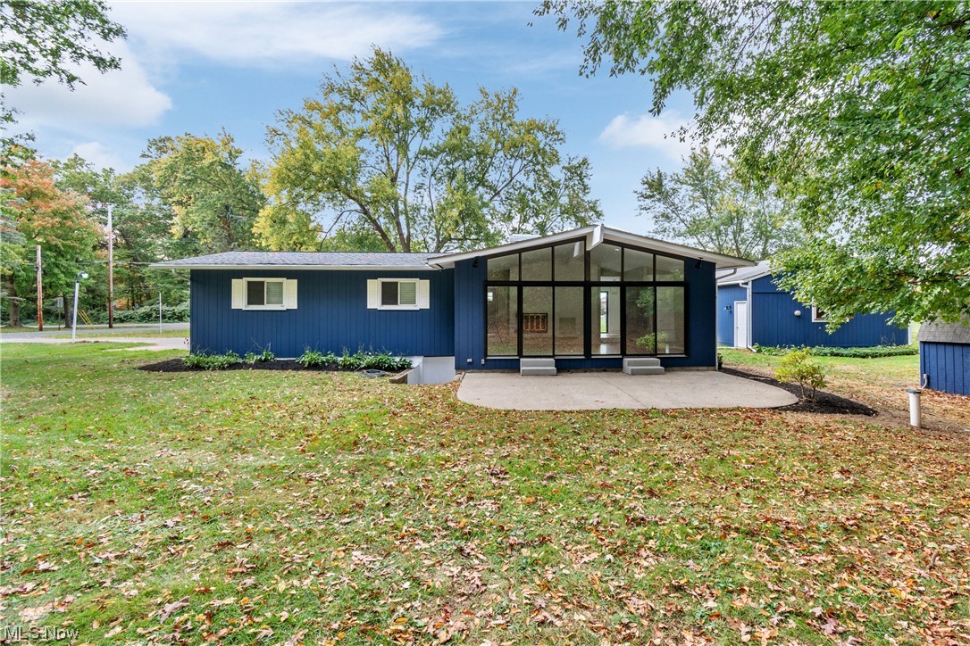 203 Pontius Road Mogadore, OH 44260 - Photo 7 of 26 Back of house featuring a sunroom and a lawn