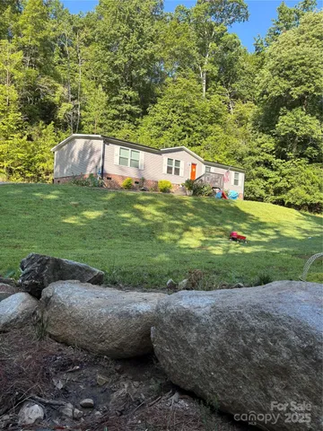 a view of a tiny house with a yard