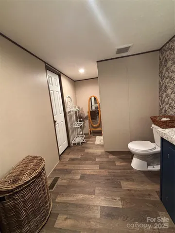 a bathroom with a sink a toilet a mirror and shower