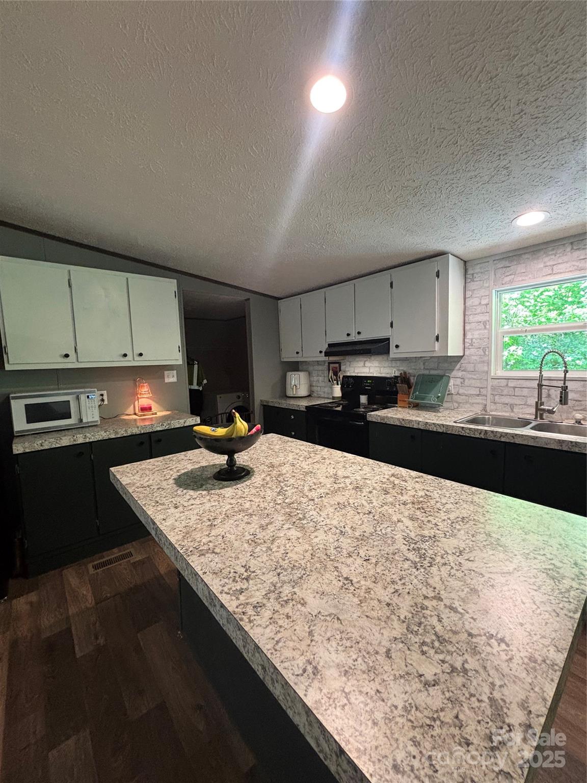 2877 Shannon Street Sharon, SC 29742 - Photo 17 of 29 a kitchen with a stove a sink and a microwave