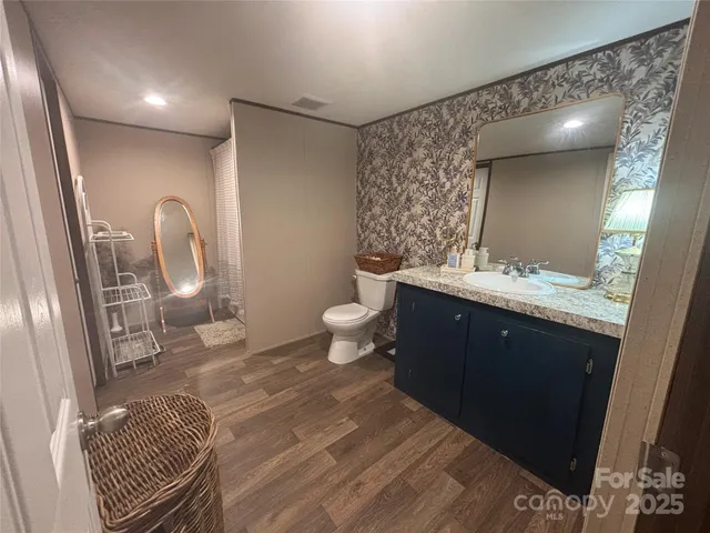 a bathroom with a double vanity sink toilet and shower