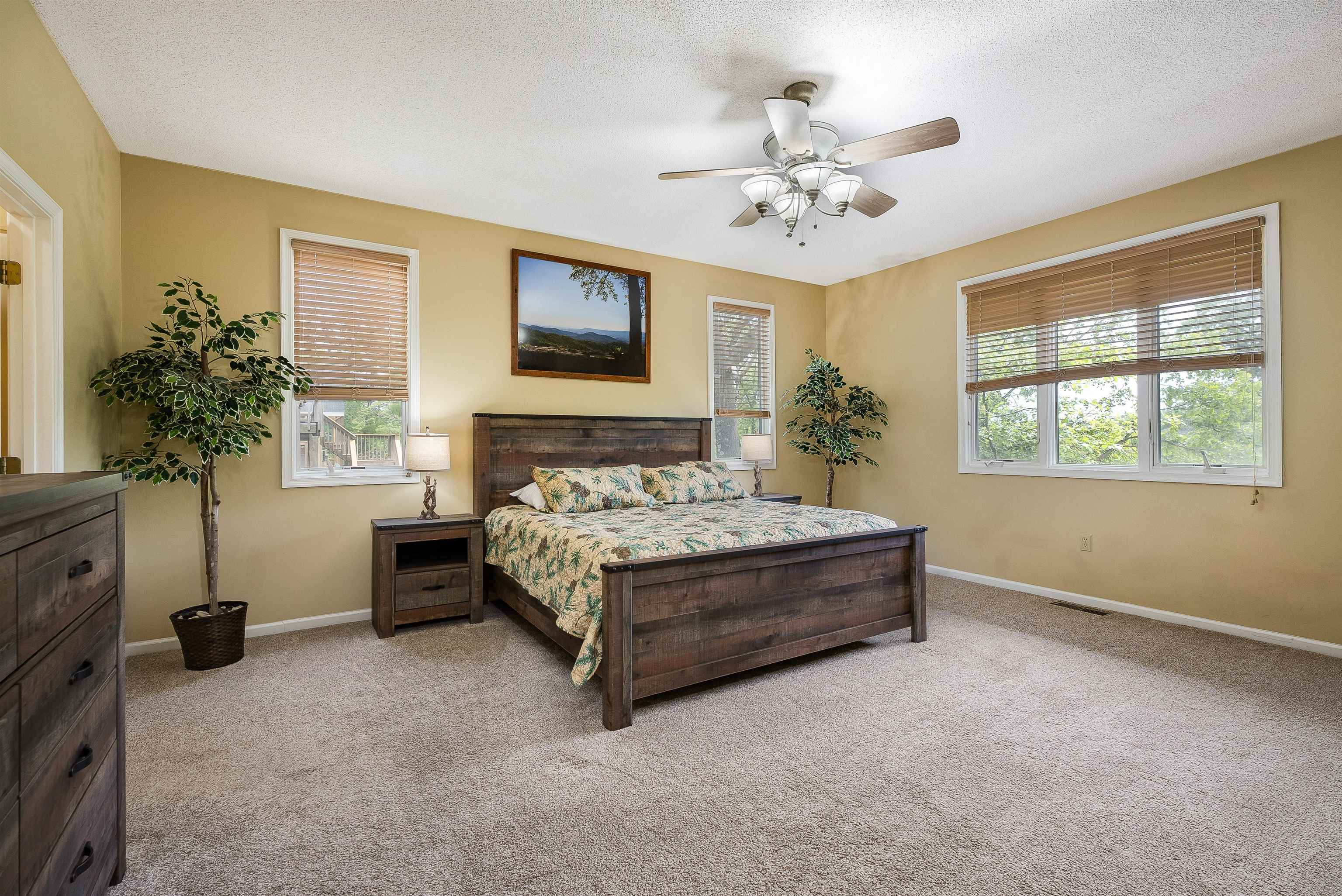 312 Rainier Road McGaheysville, VA 22840 - Photo 26 of 55 a spacious bedroom with a bed and a chandelier