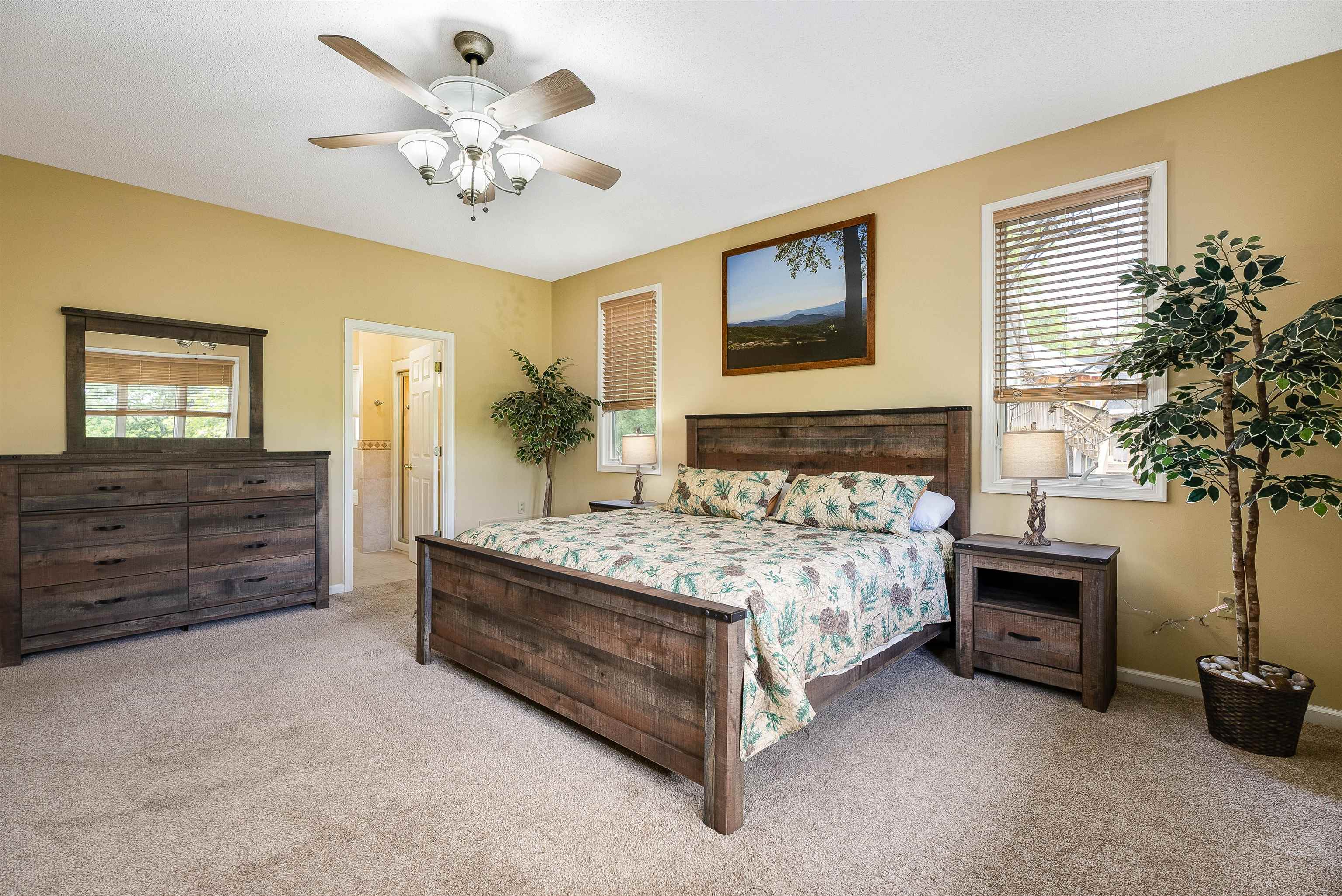 312 Rainier Road McGaheysville, VA 22840 - Photo 28 of 55 a bedroom with a bed dresser and a chandelier