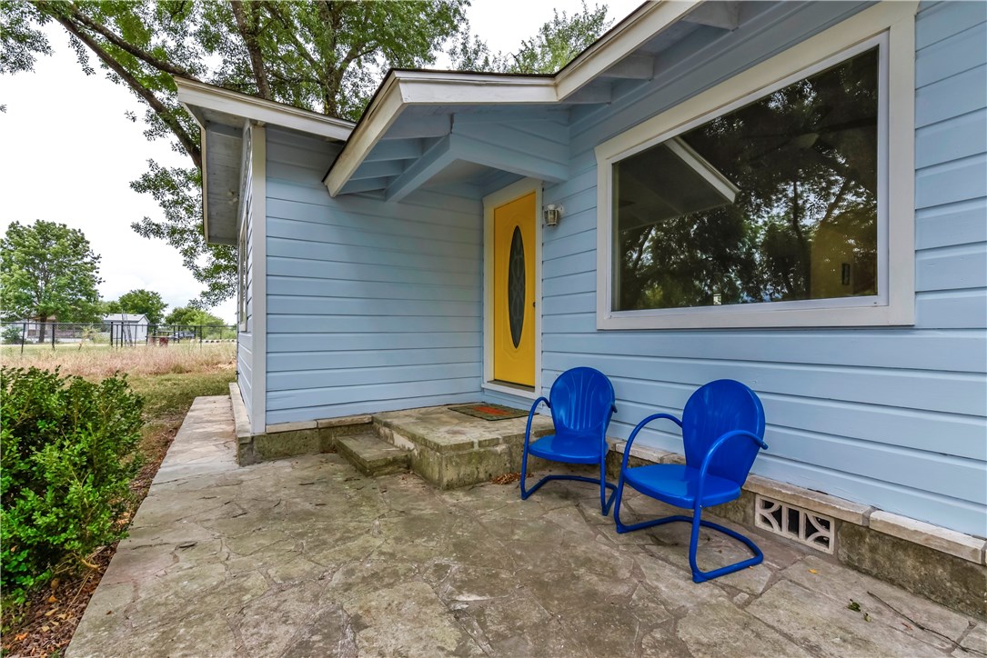 6902 Viewing Place Austin, TX 78719 - Photo 1 of 1 a backyard of a house with table and chairs