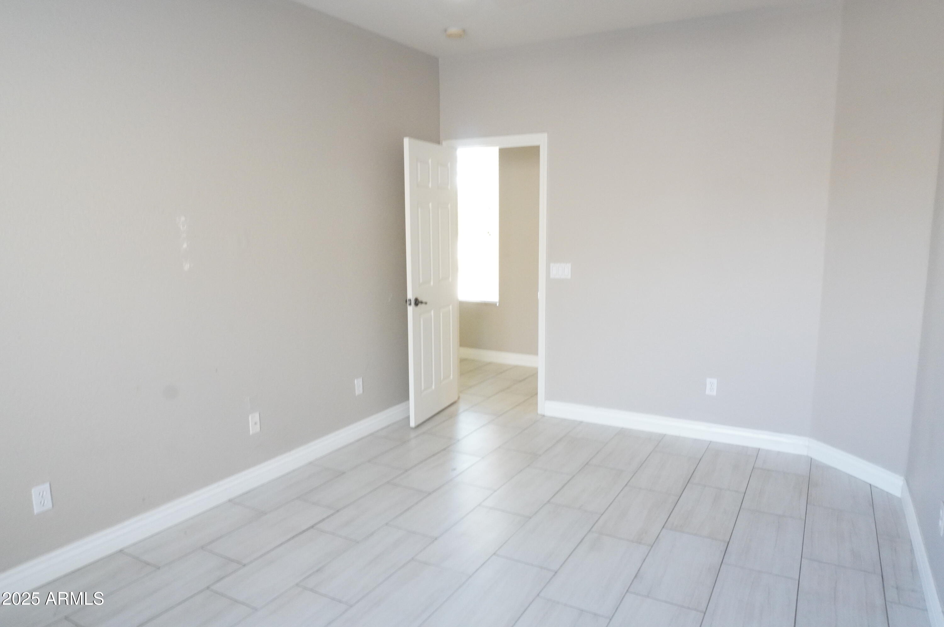 6700 South Agate Way Chandler, AZ 85249 - Photo 11 of 32 a view of an empty room with wooden floor