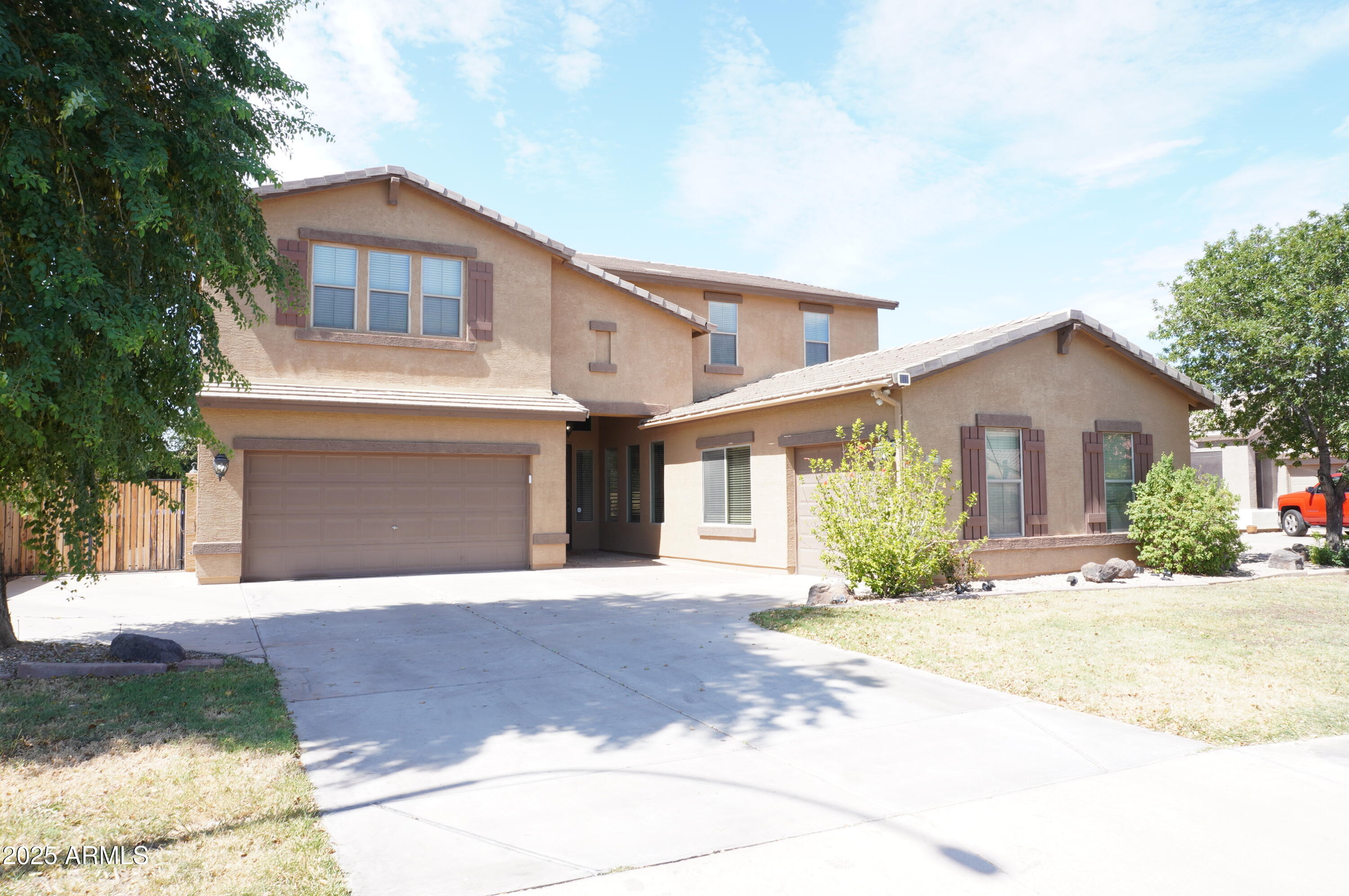 6700 South Agate Way Chandler, AZ 85249 - Photo 12 of 32 a front view of a house with a yard and garage