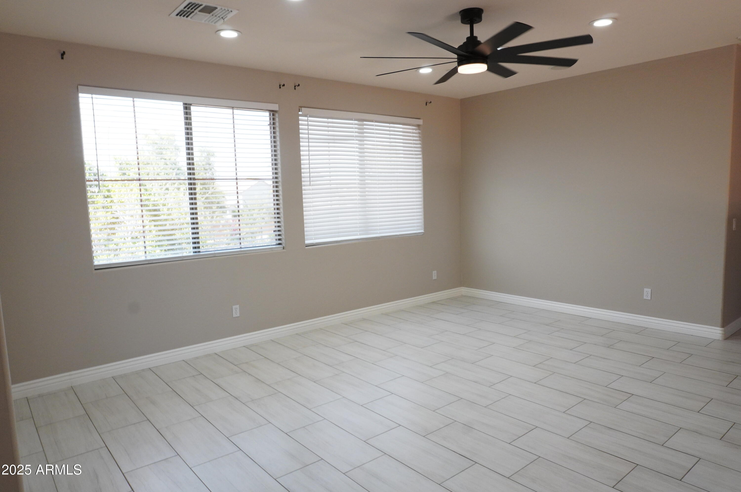 6700 South Agate Way Chandler, AZ 85249 - Photo 17 of 32 an empty room with windows and fan