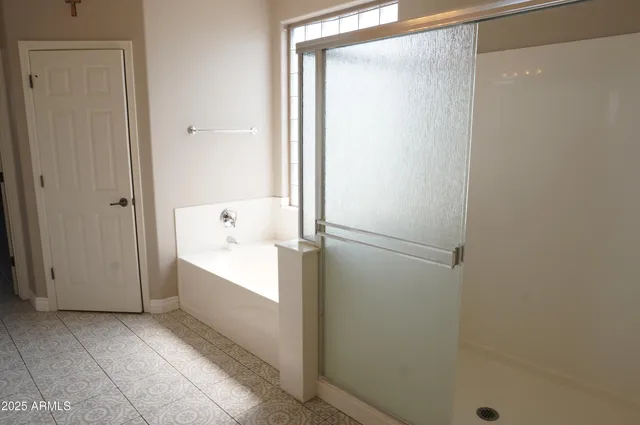 a bathroom with a bathtub and shower