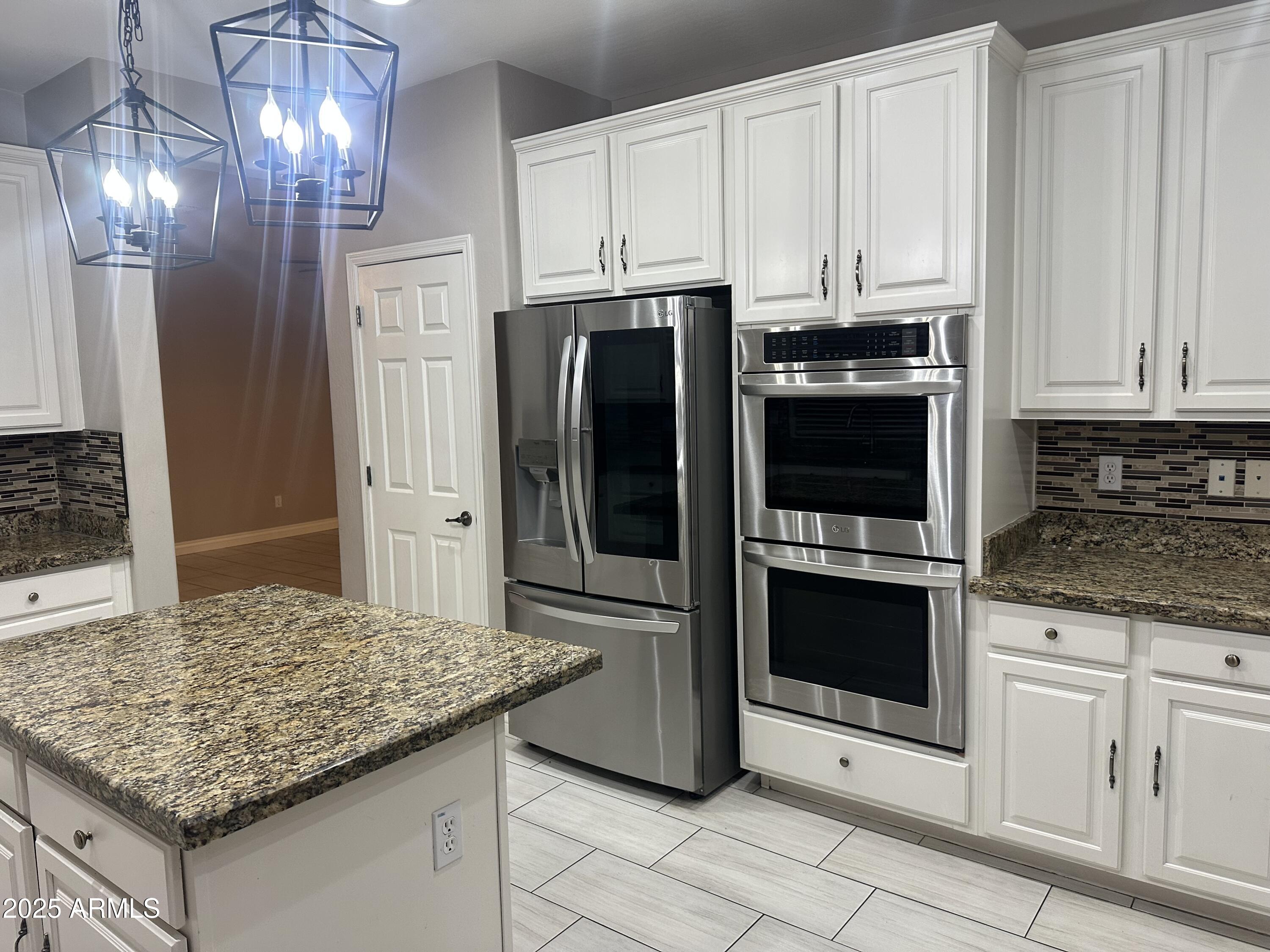 6700 South Agate Way Chandler, AZ 85249 - Photo 26 of 32 a kitchen with stainless steel appliances granite countertop a refrigerator and a stove