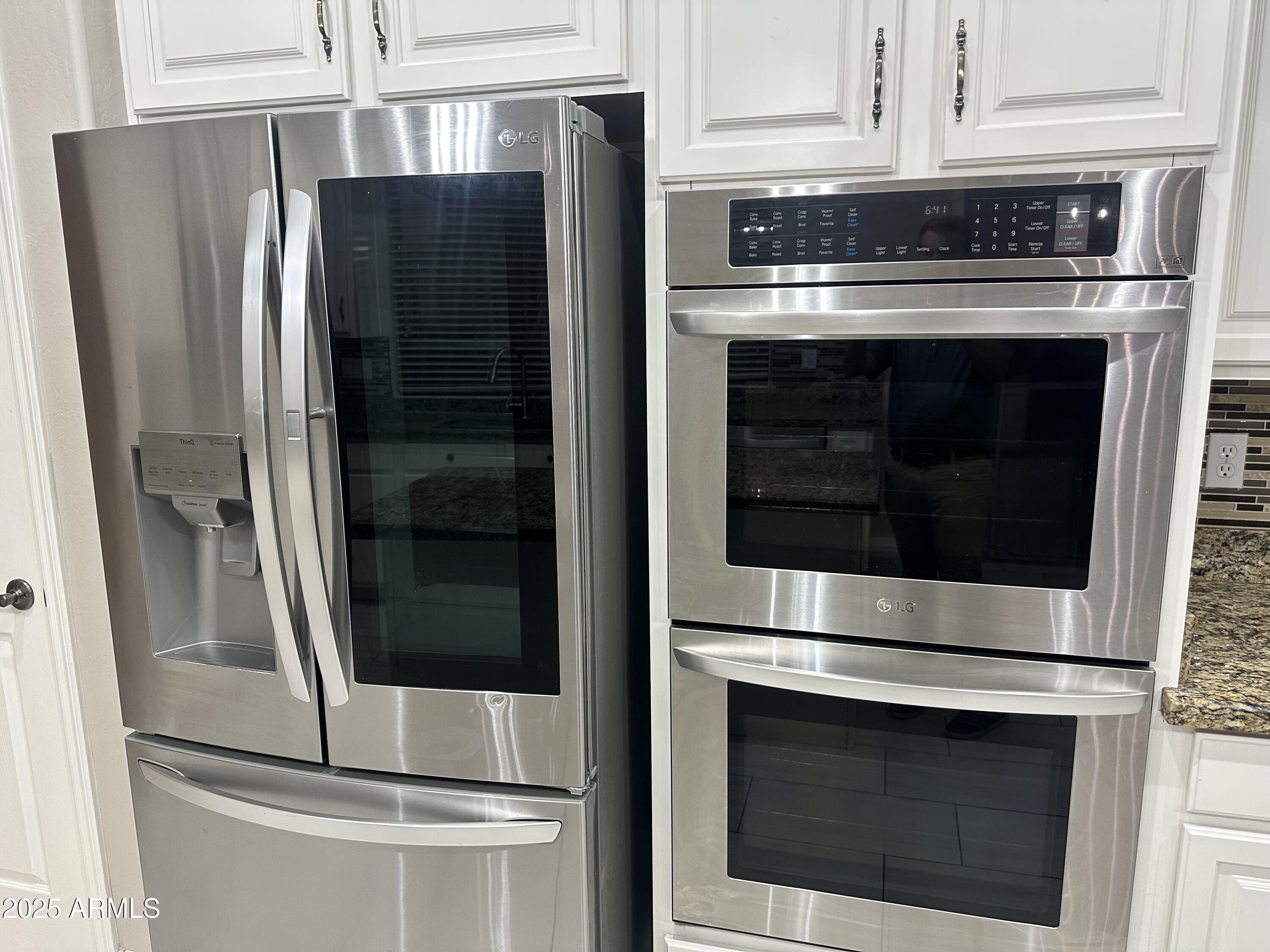 6700 South Agate Way Chandler, AZ 85249 - Photo 27 of 32 a kitchen with a stove and a refrigerator