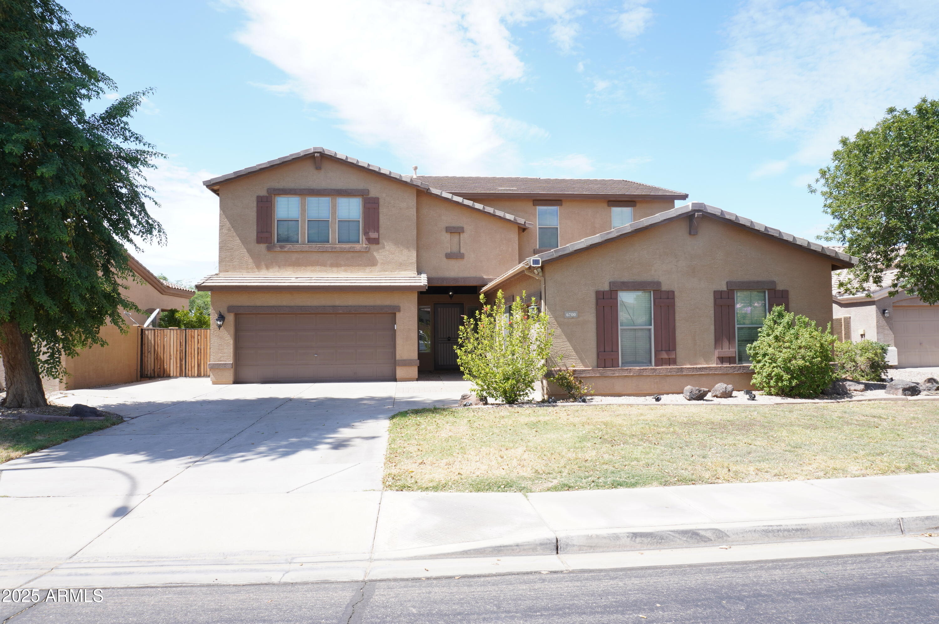 6700 South Agate Way Chandler, AZ 85249 - Photo 3 of 32 a front view of a house with a yard and garage