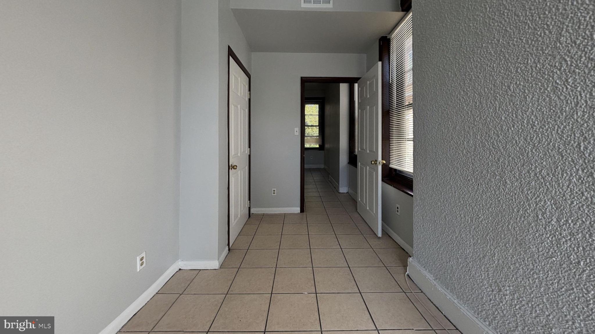 363 East Chelten Avenue, Unit 2 Philadelphia, PA 19144 - Photo 4 of 8 wooden floor in a hall with an empty room