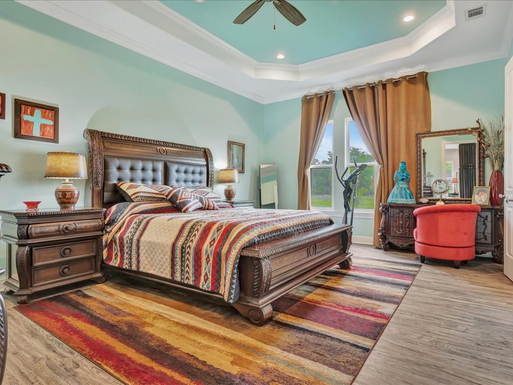104 Wheeler Road Lufkin, TX 75901 - Photo 18 of 45 a bedroom with a bed and wooden floor