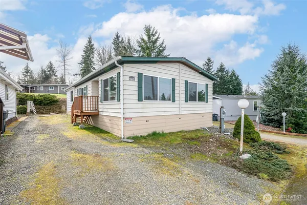 a view of a house with a yard and fence