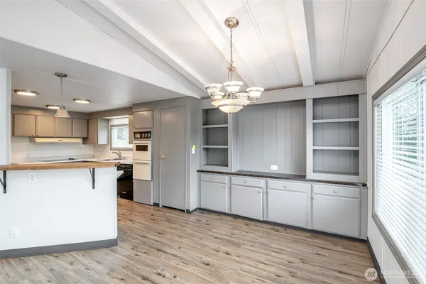 a kitchen with a sink window and cabinets