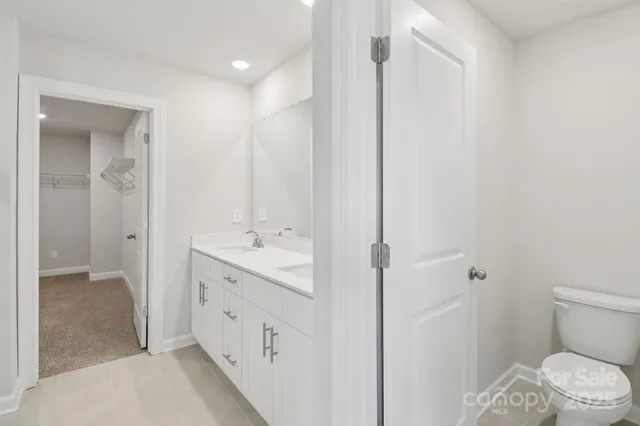 a bathroom with a double vanity sink toilet and shower