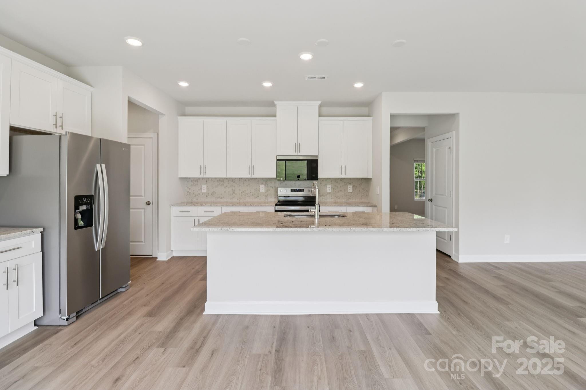 172 Murphy Mdw Road Mocksville, NC 27028 - Photo 4 of 22 a large kitchen with stainless steel appliances a large counter top a refrigerator and a stove