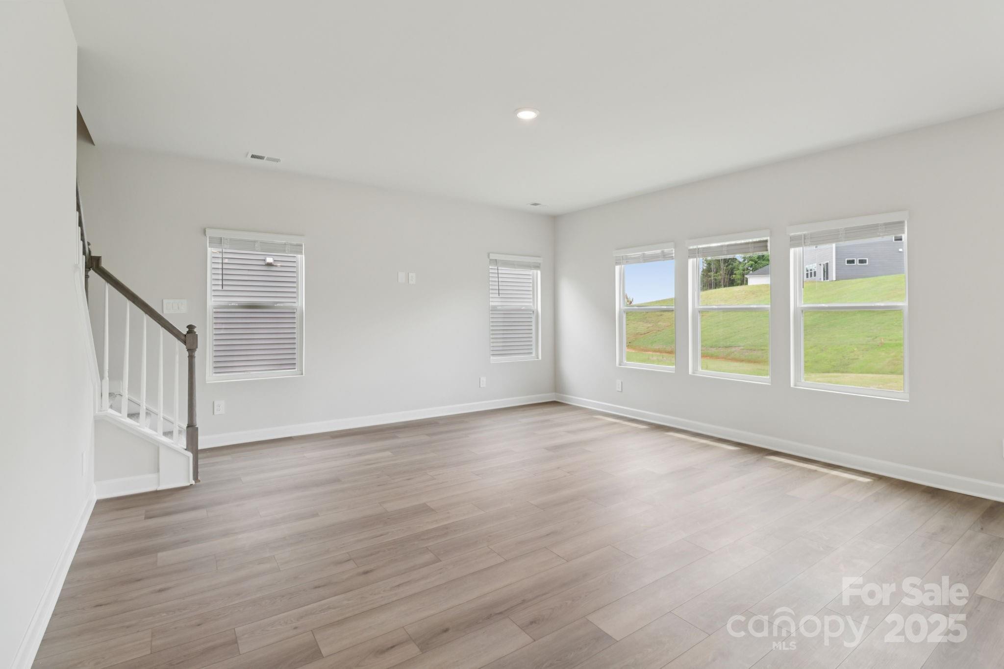 172 Murphy Mdw Road Mocksville, NC 27028 - Photo 6 of 22 a view of an empty room with wooden floor and a window